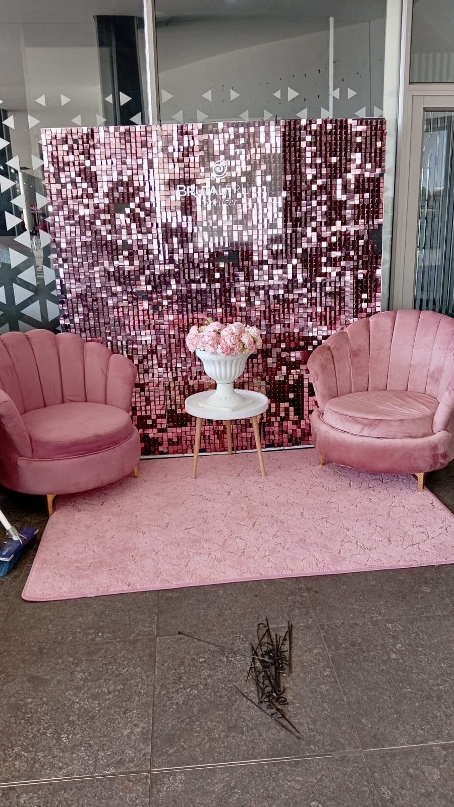 Pink lounge photo setup with sequin backdrop for a Brutal Fruit activation