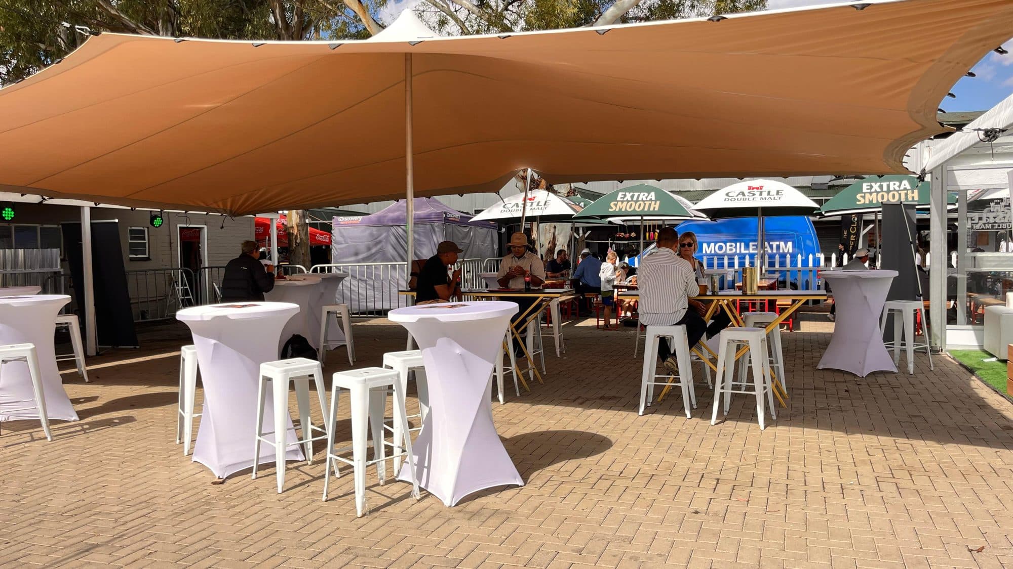 Stretch tent hospitality area with cocktail tables